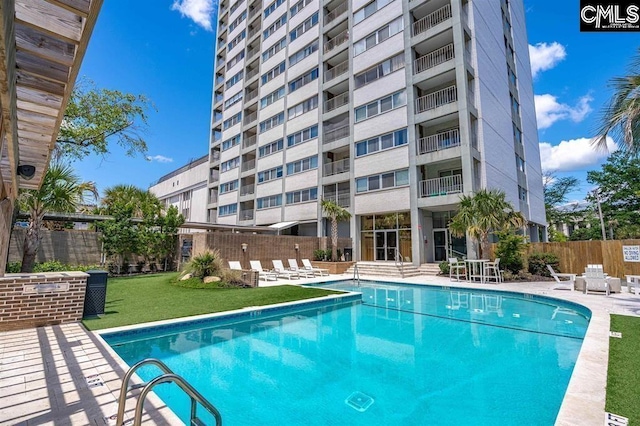 view of swimming pool with a yard and a patio