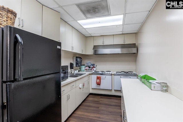 kitchen featuring dark wood-type flooring, a drop ceiling, black appliances, white cabinets, and sink