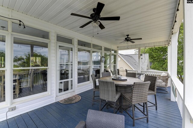 wooden terrace featuring ceiling fan