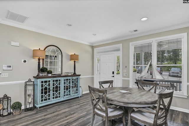 dining room with crown molding, dark hardwood / wood-style flooring, and plenty of natural light