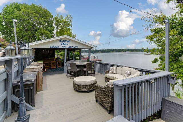 deck featuring an outdoor bar, a water view, and an outdoor hangout area