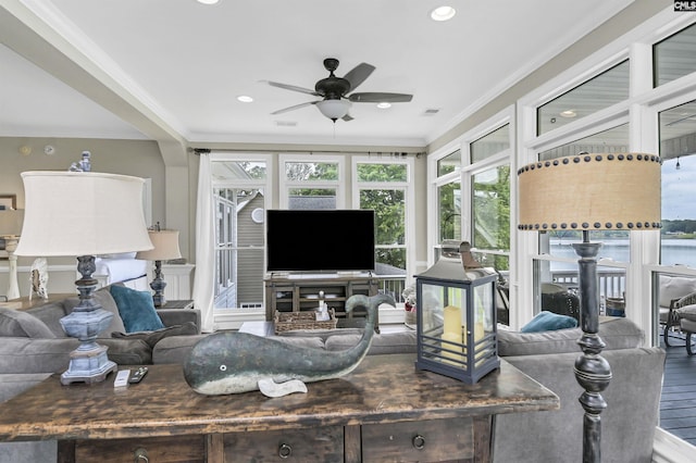 living room featuring wood-type flooring, ceiling fan, and ornamental molding