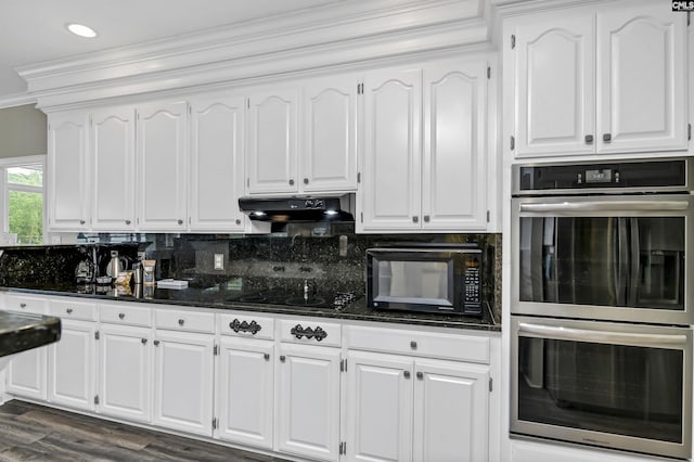 kitchen featuring black appliances, white cabinetry, and decorative backsplash