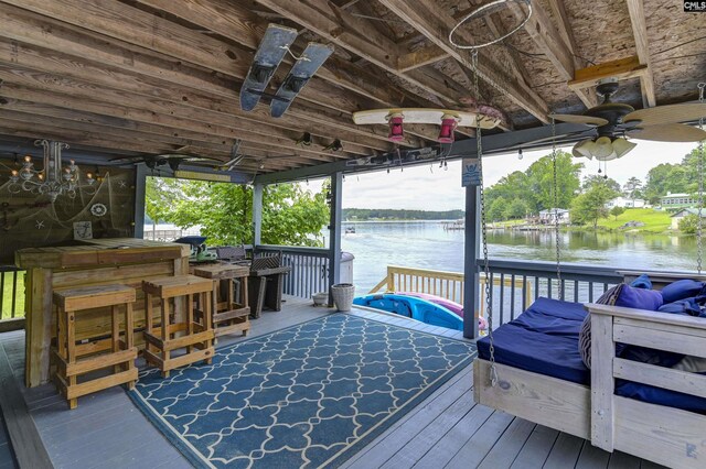 dock area with an outdoor bar and a water view