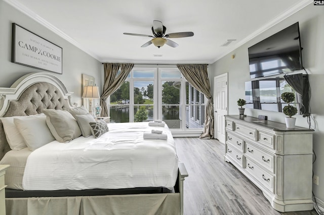 bedroom featuring ceiling fan, ornamental molding, and light hardwood / wood-style flooring