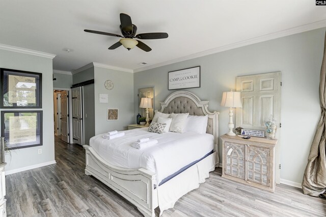 bedroom featuring ceiling fan, crown molding, and wood-type flooring