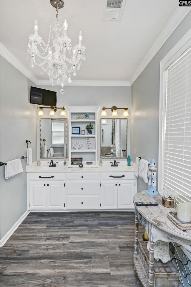 bathroom with an inviting chandelier, crown molding, vanity, and hardwood / wood-style flooring