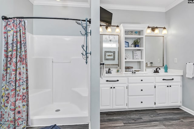 bathroom with walk in shower, crown molding, vanity, and wood-type flooring