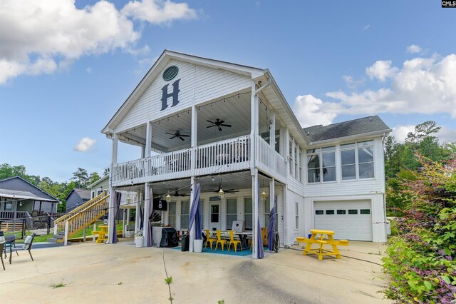 view of front facade featuring a patio area, a balcony, ceiling fan, and a garage