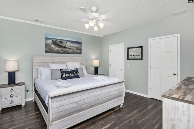 bedroom with ceiling fan, dark hardwood / wood-style flooring, and a textured ceiling