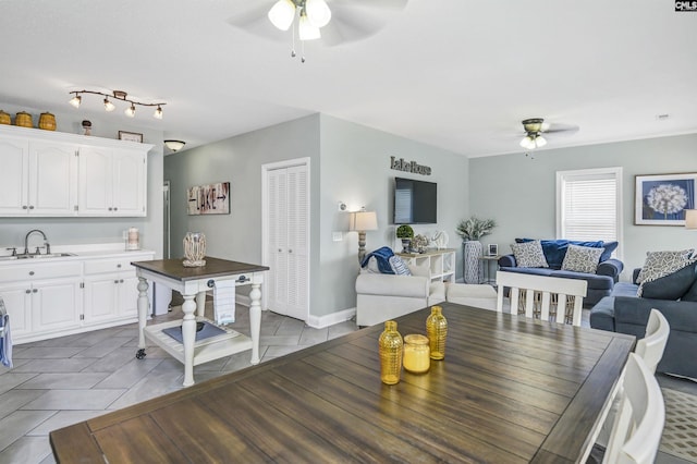 tiled dining room with sink and ceiling fan