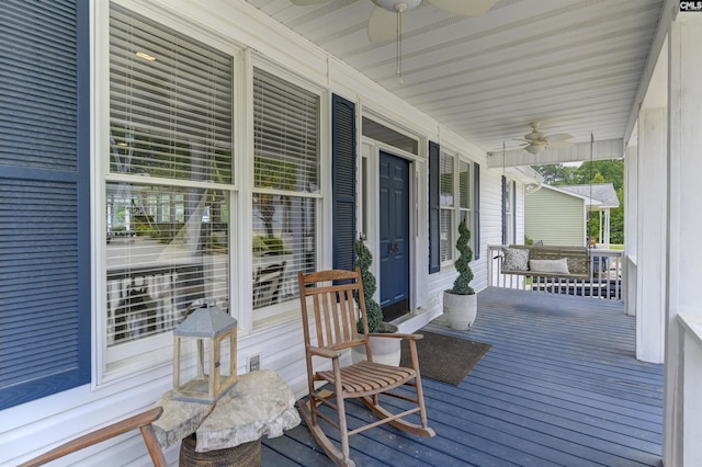 wooden terrace with covered porch and ceiling fan