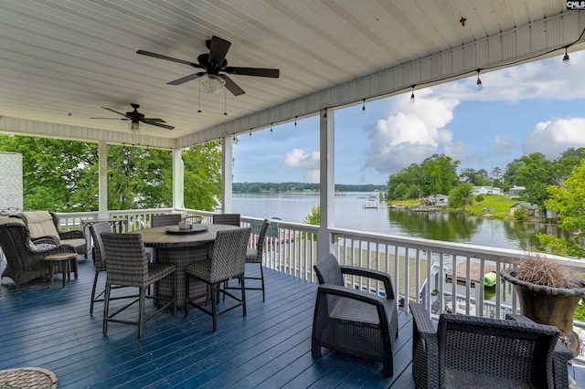 wooden deck featuring ceiling fan and a water view