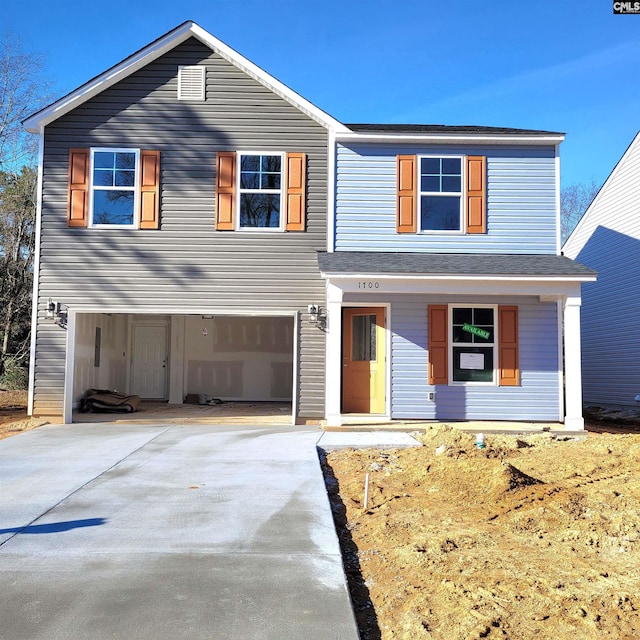 view of front of property with a garage and covered porch