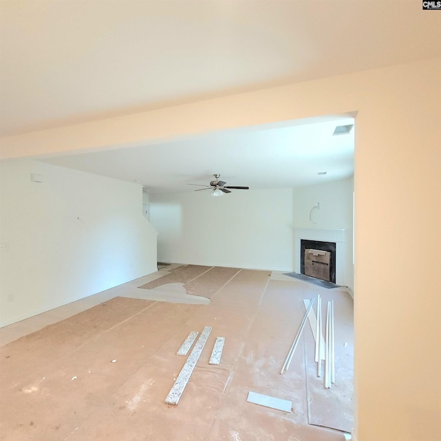 unfurnished living room with ceiling fan