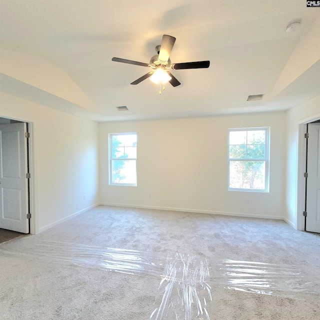 unfurnished room with lofted ceiling, ceiling fan, and a healthy amount of sunlight