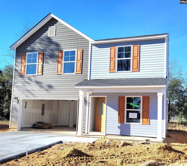 view of front of property with covered porch and a garage