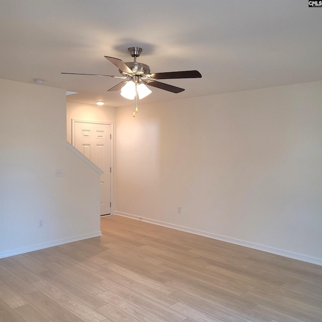 spare room with ceiling fan and light wood-type flooring