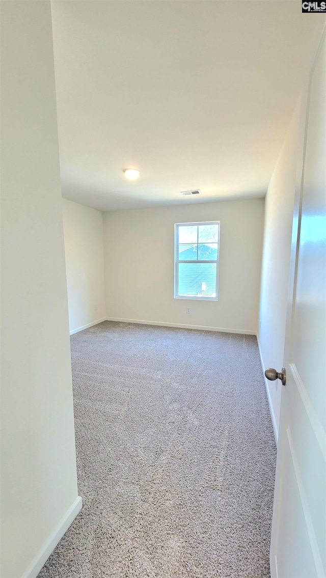 unfurnished room featuring visible vents, carpet flooring, and baseboards