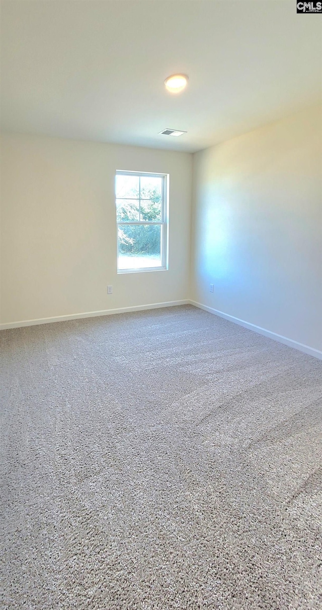 empty room with baseboards and visible vents
