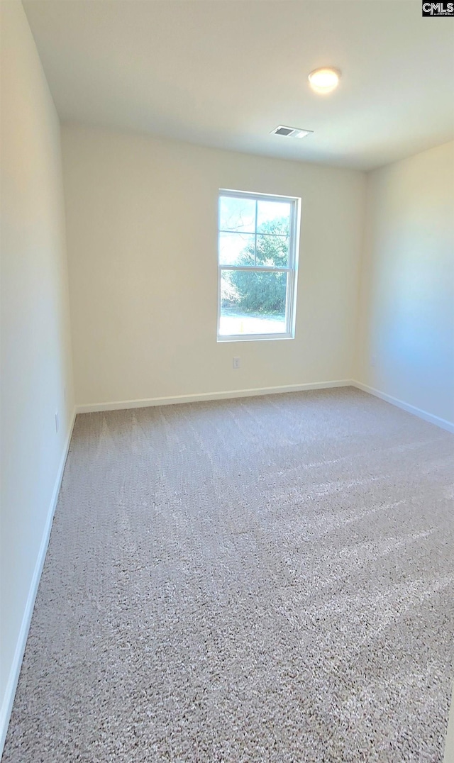 unfurnished room with visible vents and baseboards
