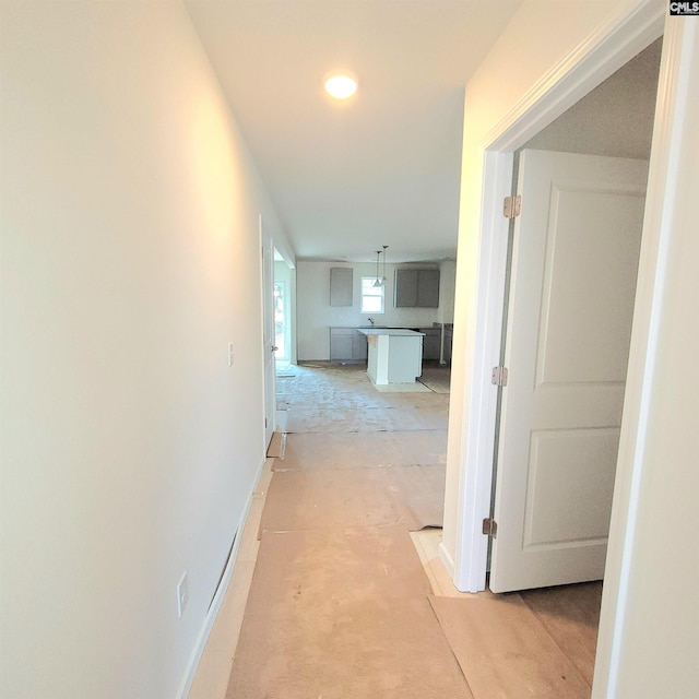 hallway featuring baseboards