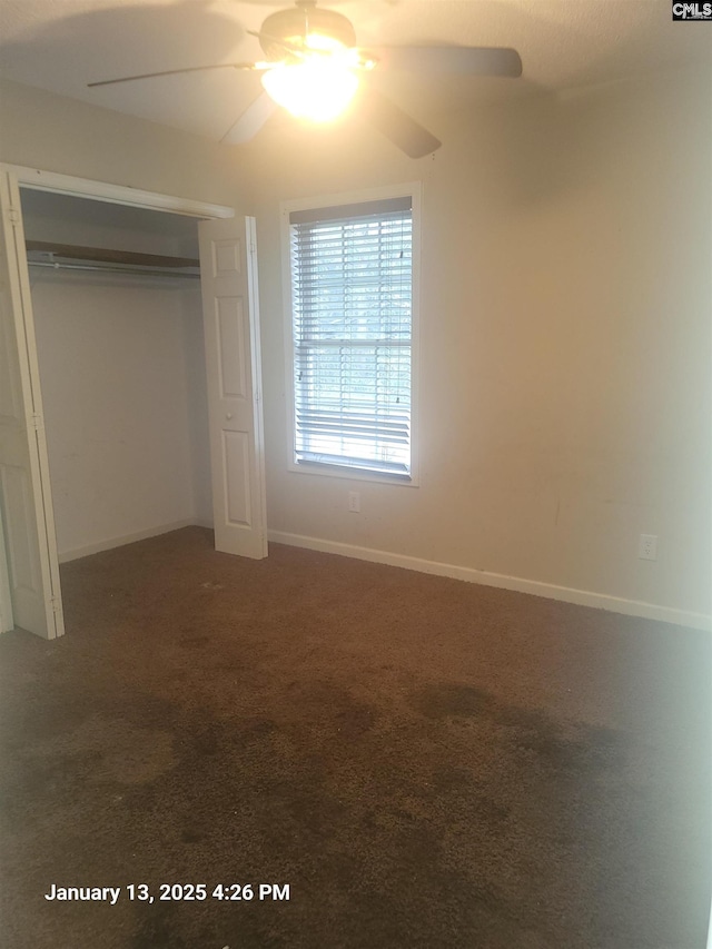 unfurnished bedroom featuring carpet flooring, ceiling fan, and a closet