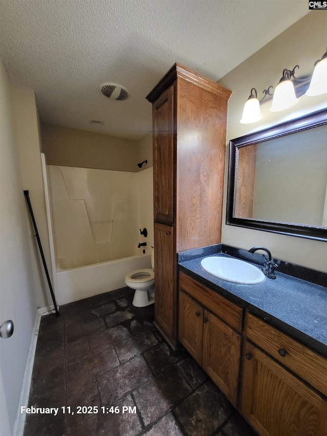 full bathroom with bathing tub / shower combination, vanity, a textured ceiling, and toilet