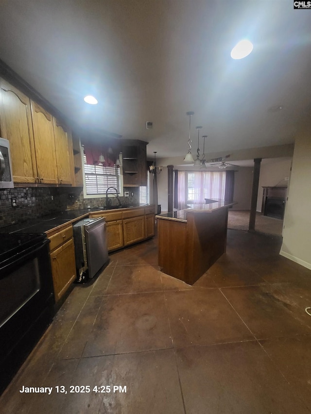 kitchen featuring sink, hanging light fixtures, backsplash, stainless steel appliances, and a kitchen island