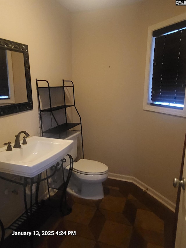 bathroom with sink, tile patterned floors, and toilet