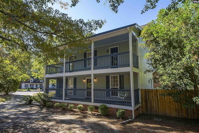 view of front of house with a balcony and covered porch