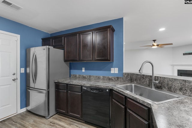 kitchen with sink, dishwasher, ceiling fan, light hardwood / wood-style flooring, and stainless steel fridge