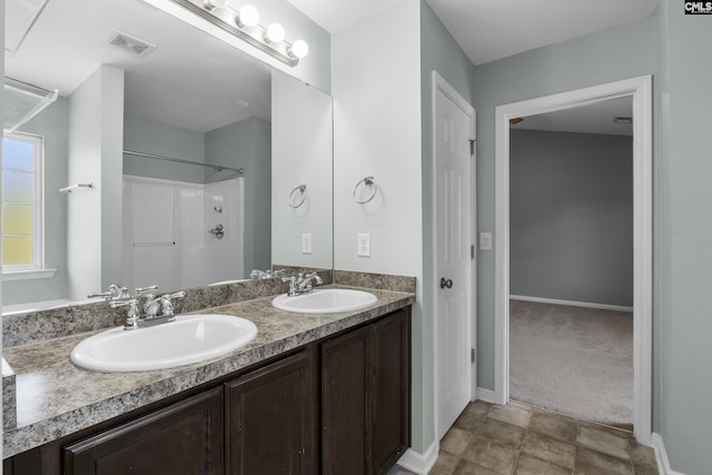 bathroom featuring a shower and vanity