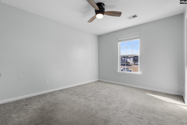 carpeted empty room featuring ceiling fan