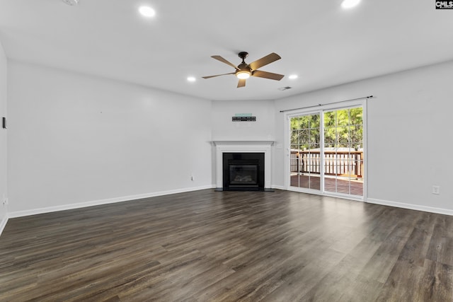 unfurnished living room with ceiling fan and dark wood-type flooring