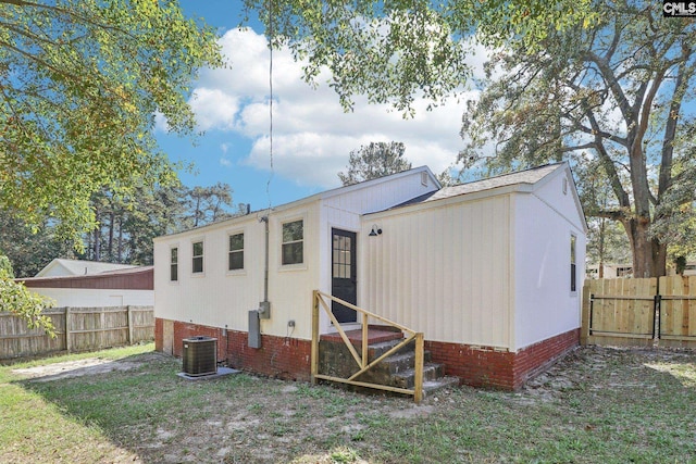 rear view of house with central AC unit