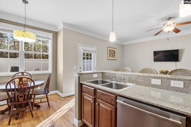 kitchen with dishwasher, crown molding, hanging light fixtures, and sink