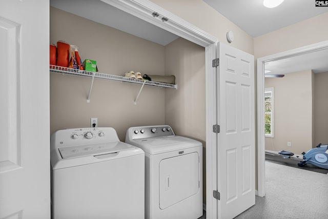 laundry room featuring washing machine and clothes dryer and carpet flooring