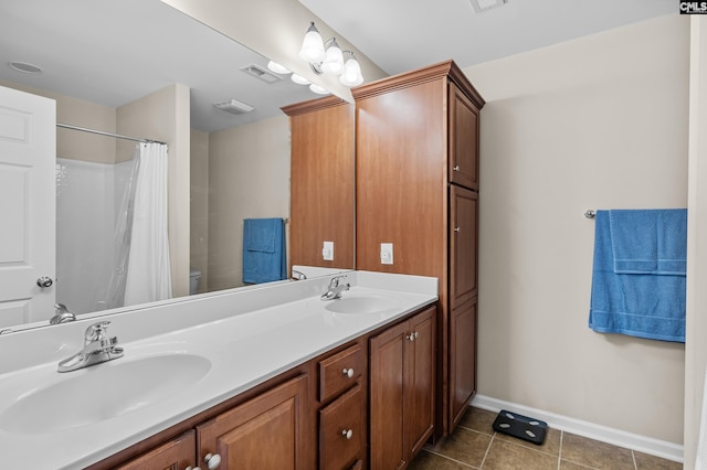 bathroom featuring toilet, vanity, and tile patterned floors