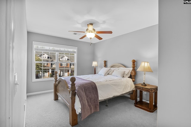 bedroom featuring light colored carpet and ceiling fan