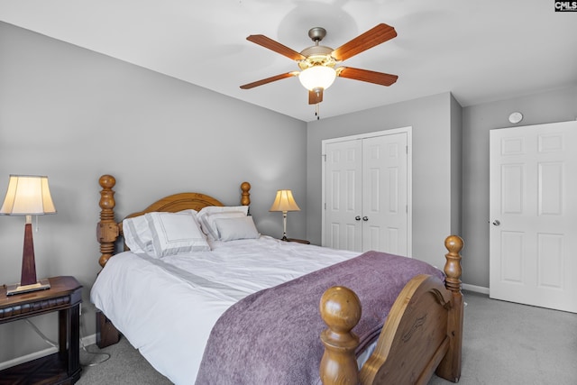 bedroom with ceiling fan, a closet, and light carpet