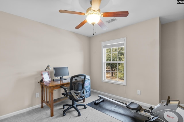 carpeted office space featuring ceiling fan