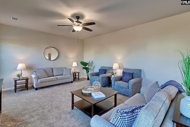 living room with ceiling fan and light colored carpet