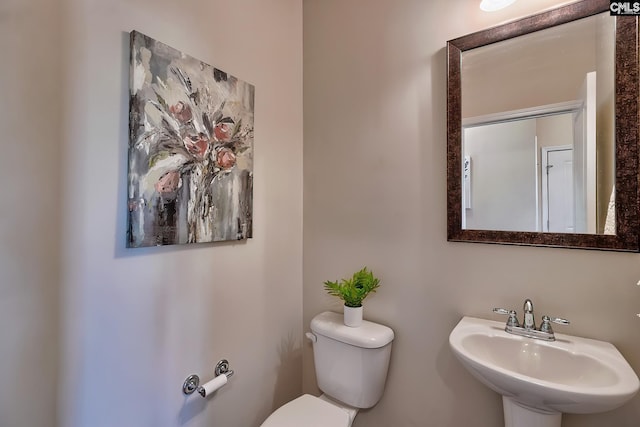 bathroom featuring sink and toilet