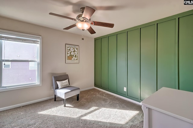 living area with ceiling fan and carpet flooring