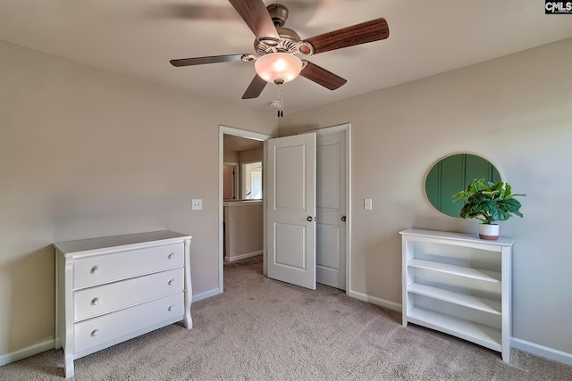 unfurnished bedroom featuring light carpet and ceiling fan