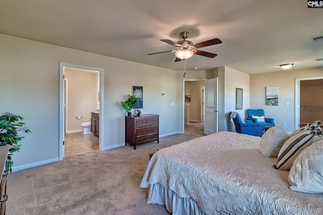 carpeted bedroom with ensuite bath, ceiling fan, a spacious closet, and a closet