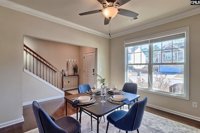 dining area featuring ceiling fan, crown molding, a wealth of natural light, and dark hardwood / wood-style floors