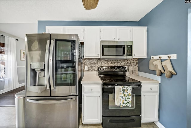 kitchen with a textured ceiling, appliances with stainless steel finishes, backsplash, and white cabinetry