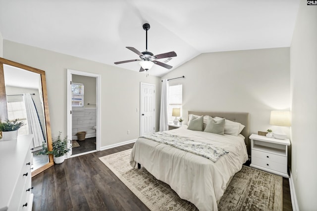 bedroom with lofted ceiling, ceiling fan, dark hardwood / wood-style floors, and connected bathroom